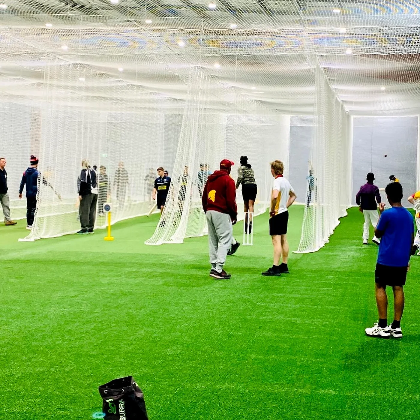 Coaches and juniors in the Hoppers Crossing nets